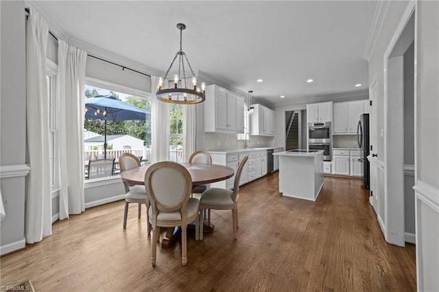 1203 Westminster Dr, Greensboro, NC 27410 - dining area with a chandelier, crown molding, wood finished floors, and recessed lighting