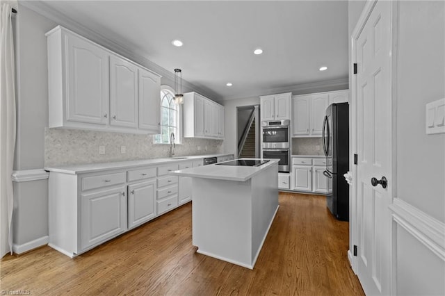 1203 Westminster Dr, Greensboro, NC 27410 - kitchen featuring freestanding refrigerator, double oven, white cabinets, black electric stovetop, and recessed lighting