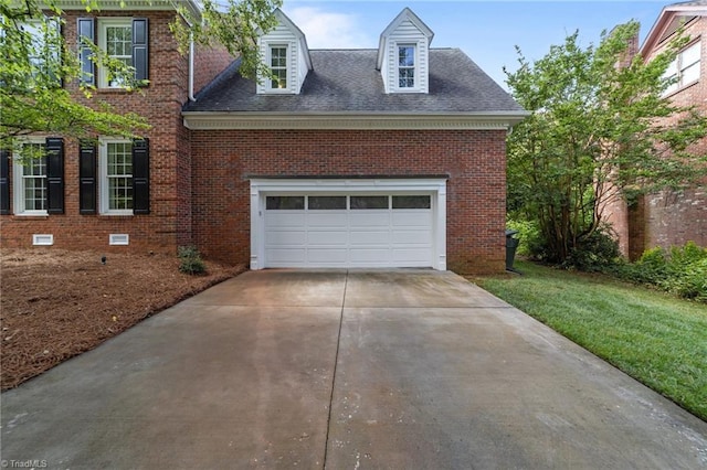 1203 Westminster Dr, Greensboro, NC 27410 - view of front of home with brick siding, driveway, a garage, and a shingled roof