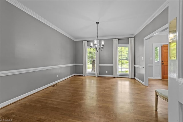 1203 Westminster Dr, Greensboro, NC 27410 - unfurnished dining area featuring a chandelier, crown molding, and wood finished floors