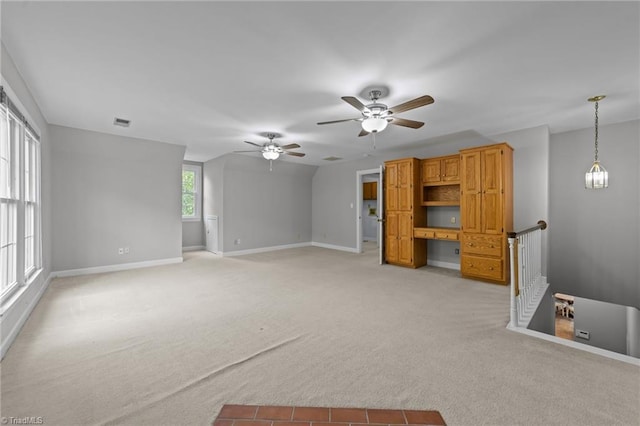 1203 Westminster Dr, Greensboro, NC 27410 - unfurnished living room featuring light colored carpet and ceiling fan