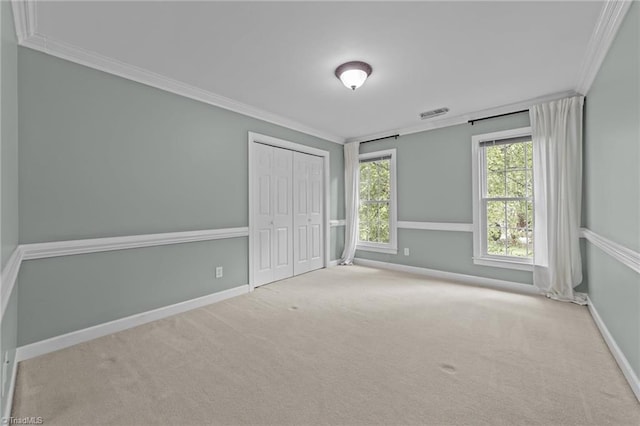 1203 Westminster Dr, Greensboro, NC 27410 - unfurnished bedroom featuring crown molding, carpet flooring, and a closet