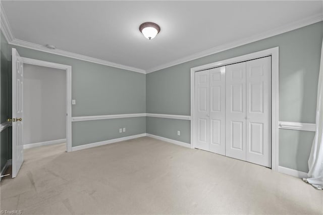 1203 Westminster Dr, Greensboro, NC 27410 - unfurnished bedroom featuring carpet, crown molding, and a closet