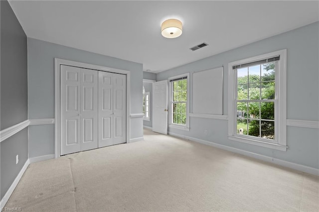 1203 Westminster Dr, Greensboro, NC 27410 - unfurnished bedroom featuring carpet flooring and a closet