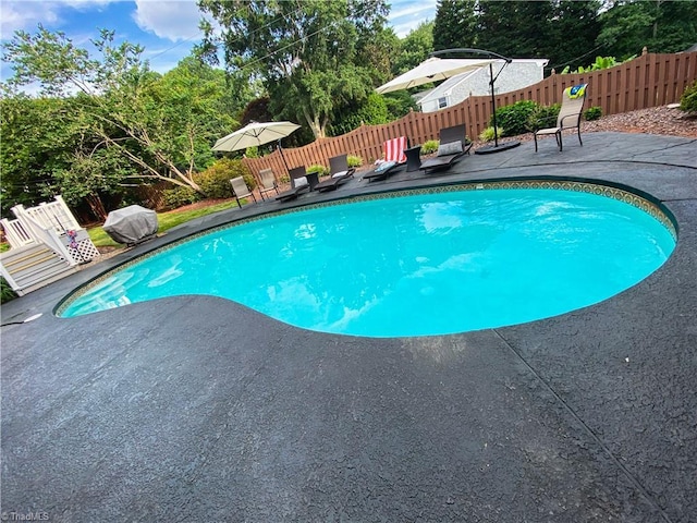 1203 Westminster Dr, Greensboro, NC 27410 - view of pool featuring a patio, a grill, and view of wooded area