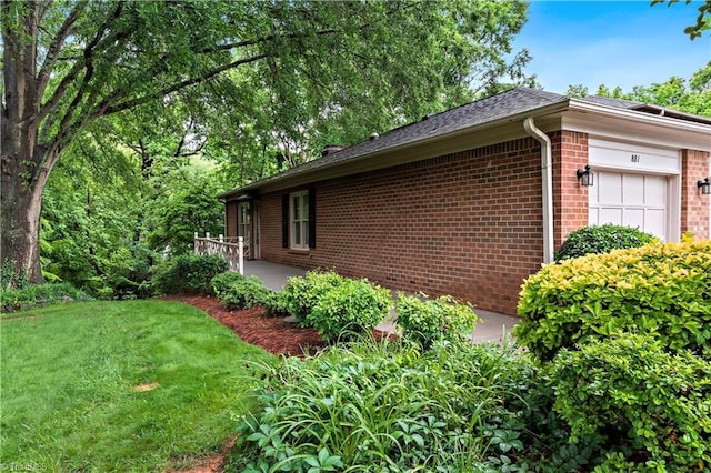 881 Brookleigh Ct, Winston-Salem, NC 27104 - view of home's exterior with brick siding, a yard, and a garage