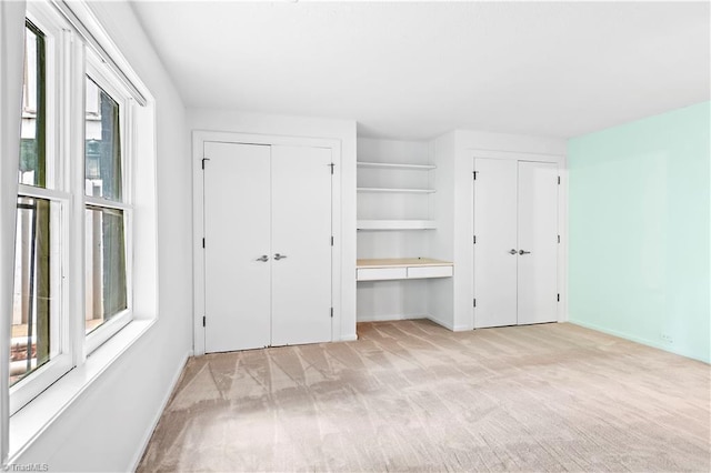 881 Brookleigh Ct, Winston-Salem, NC 27104 - unfurnished bedroom featuring two closets, light carpet, and baseboards