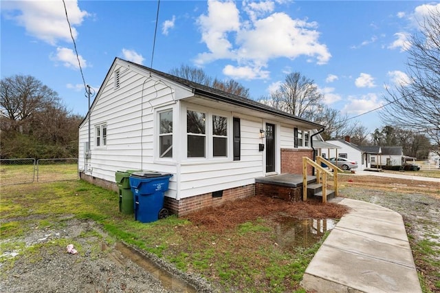 bungalow-style house featuring a gate, fence, and crawl space