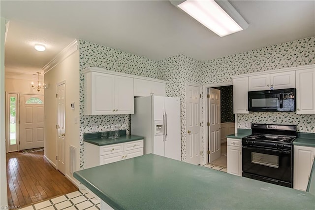 4317 Bradbury Way, High Point, NC 27265 - kitchen with black appliances, a chandelier, dark countertops, white cabinets, and ornamental molding
