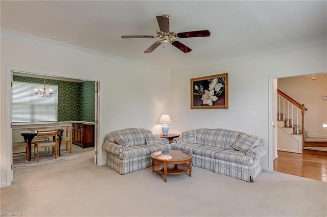4317 Bradbury Way, High Point, NC 27265 - carpeted living area featuring a chandelier, ornamental molding, stairs, and a ceiling fan