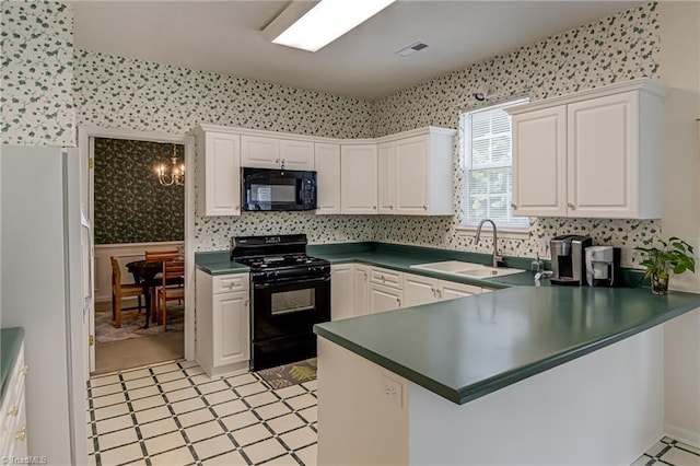 4317 Bradbury Way, High Point, NC 27265 - kitchen with black appliances, wallpapered walls, dark countertops, a peninsula, and white cabinetry