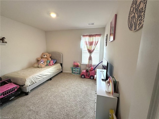 carpeted bedroom featuring visible vents