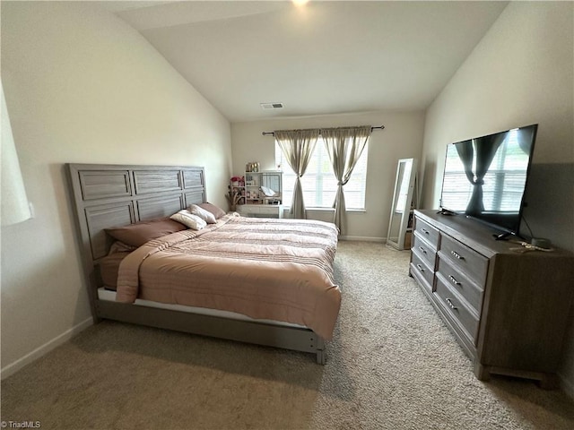 bedroom featuring light carpet, visible vents, baseboards, and vaulted ceiling