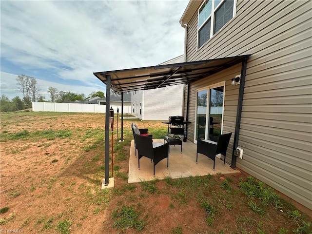 exterior space featuring fence and a grill