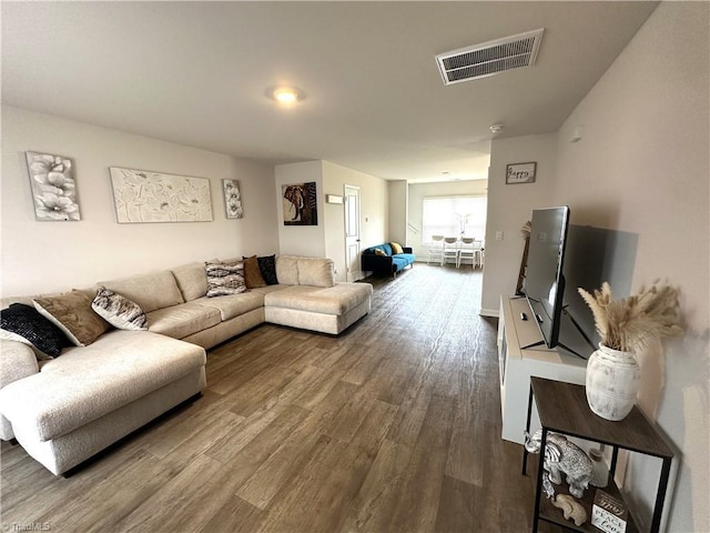 living area featuring visible vents and dark wood-style floors