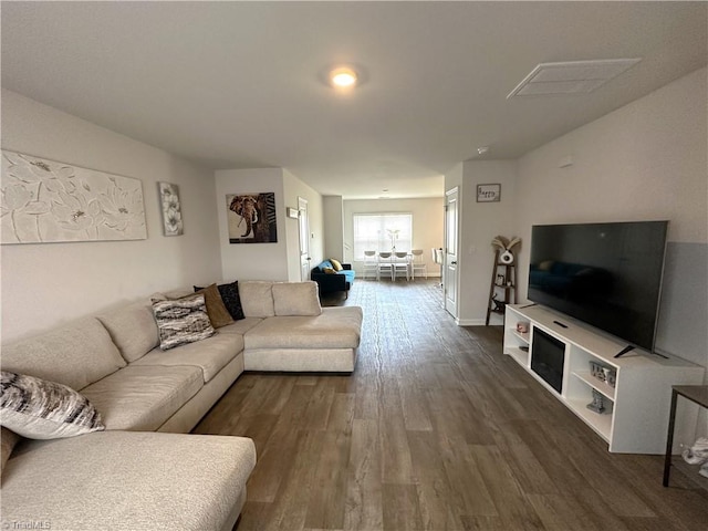 living area with dark wood-style floors and baseboards