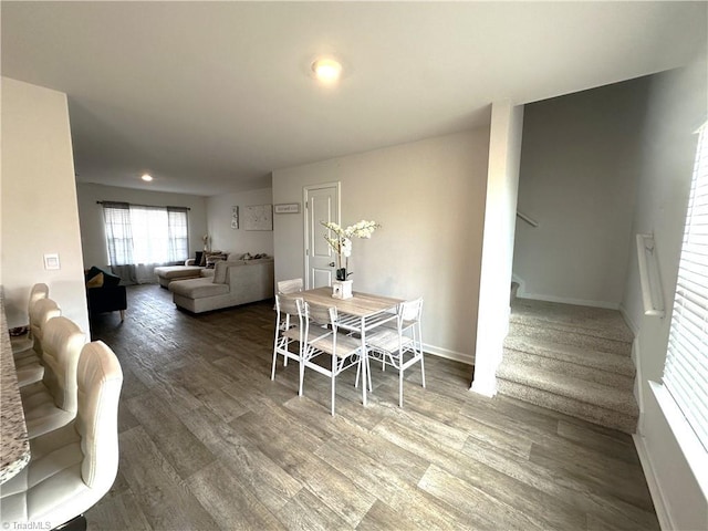 dining space with recessed lighting, baseboards, stairway, and wood finished floors