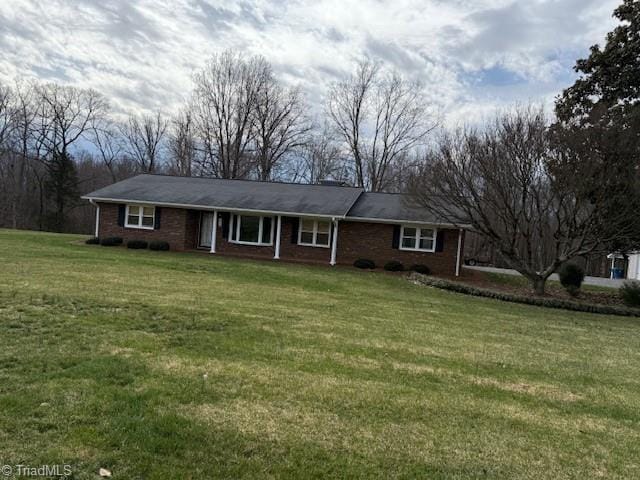 single story home with brick siding and a front yard