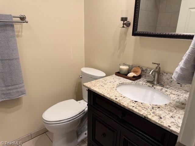 bathroom featuring tile patterned floors, toilet, and vanity