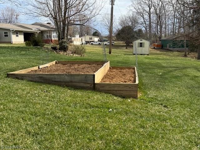 view of yard featuring an outbuilding, a garden, and a storage unit