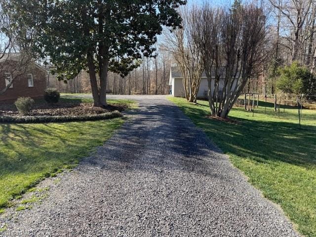 view of street featuring gravel driveway