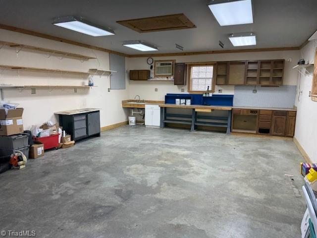 garage with a workshop area, baseboards, and a sink