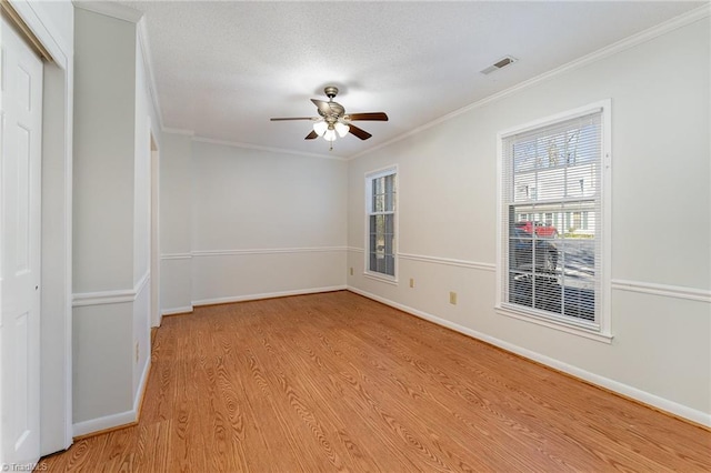 unfurnished bedroom with a closet, light hardwood / wood-style floors, ceiling fan, and crown molding