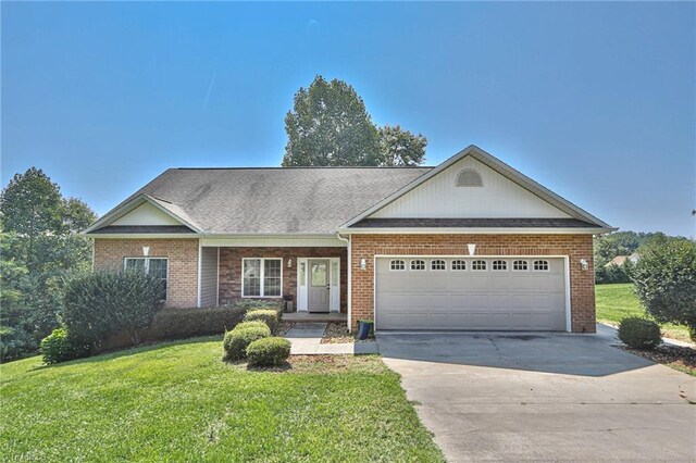 view of front of home with a garage and a front lawn