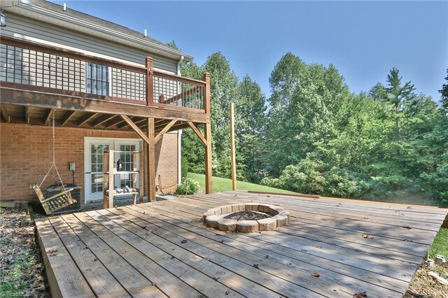 wooden terrace featuring a playground