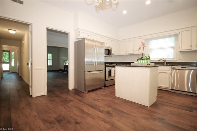 39 Fountain Manor Dr Unit A, Greensboro, NC 27405 - kitchen featuring stainless steel appliances, dark countertops, a sink, white cabinets, and dark wood-type flooring