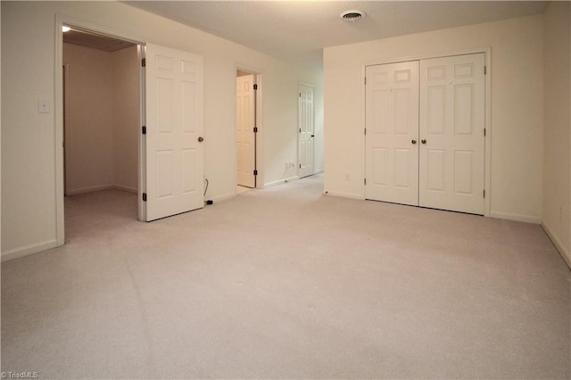 39 Fountain Manor Dr Unit A, Greensboro, NC 27405 - unfurnished bedroom featuring a closet, light colored carpet, and baseboards