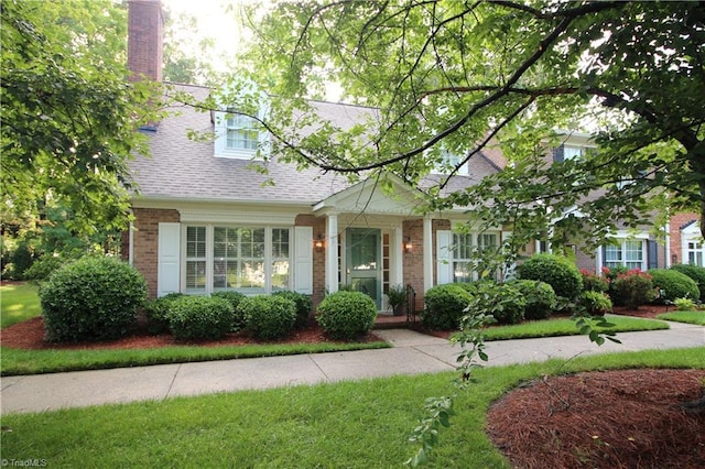 39 Fountain Manor Dr Unit A, Greensboro, NC 27405 - view of front of house featuring brick siding, roof with shingles, and a chimney