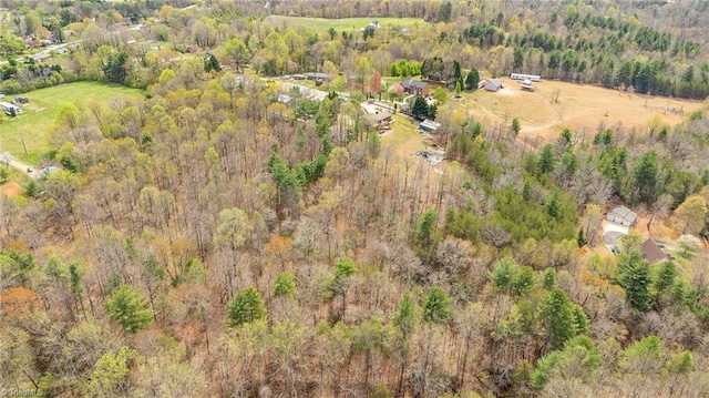 birds eye view of property featuring a view of trees