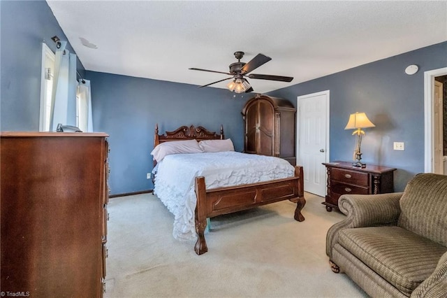 bedroom with baseboards, carpet flooring, and a ceiling fan