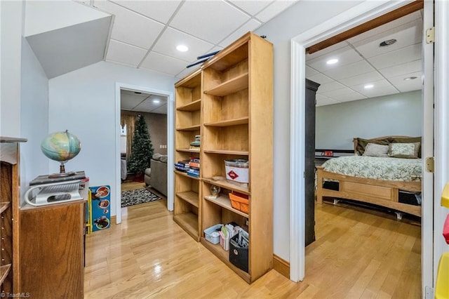 interior space with light wood-style flooring and a drop ceiling