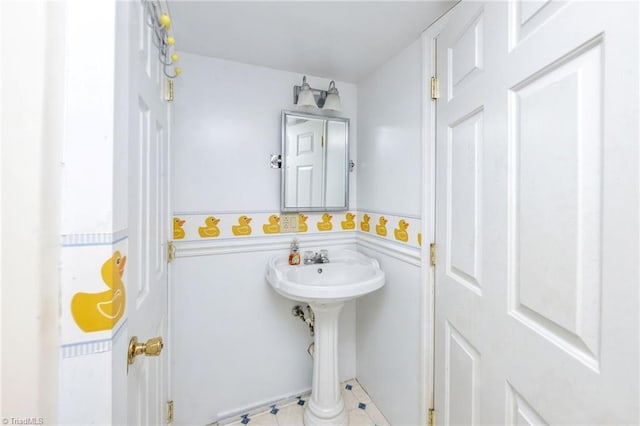 bathroom with a sink and wainscoting