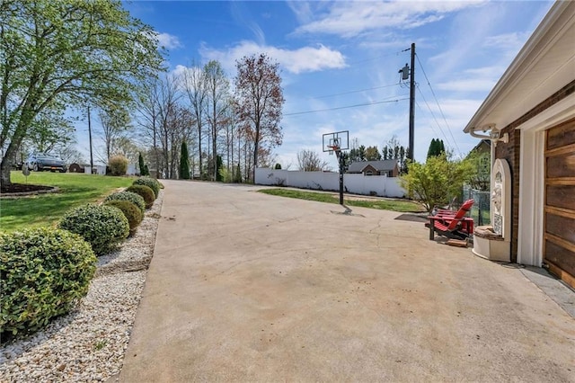 view of road featuring concrete driveway