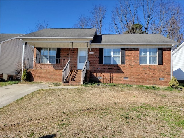 view of front facade featuring crawl space, brick siding, a porch, and a shingled roof