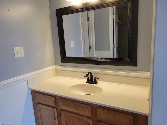 bathroom featuring a wainscoted wall and vanity