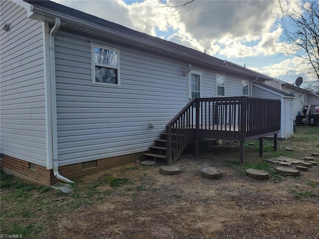 rear view of house featuring crawl space and a deck