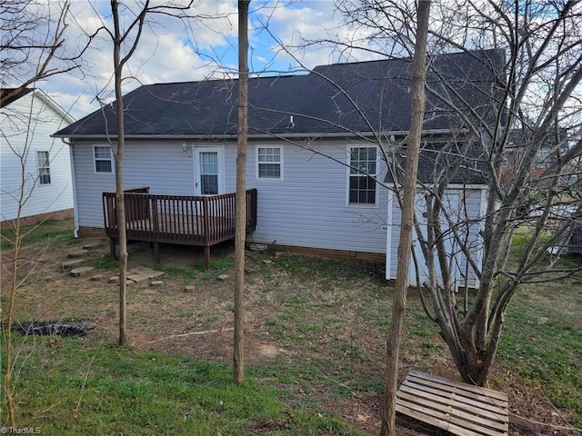 back of house with crawl space, a wooden deck, and roof with shingles