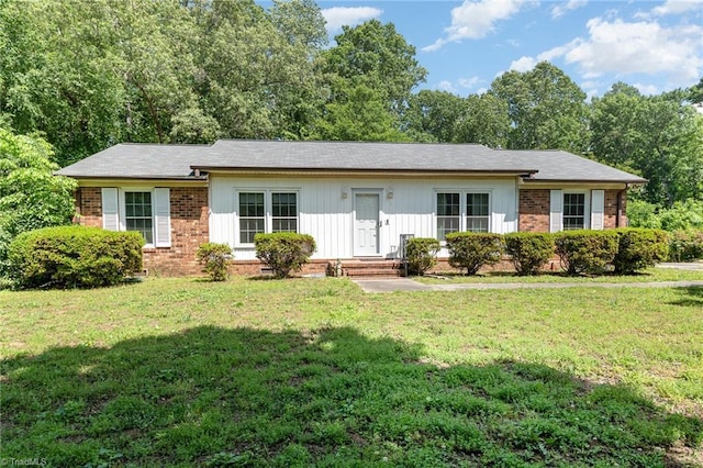 6215 Russwood Dr, Pleasant Garden, NC 27313 - ranch-style house with brick siding, a front yard, and board and batten siding