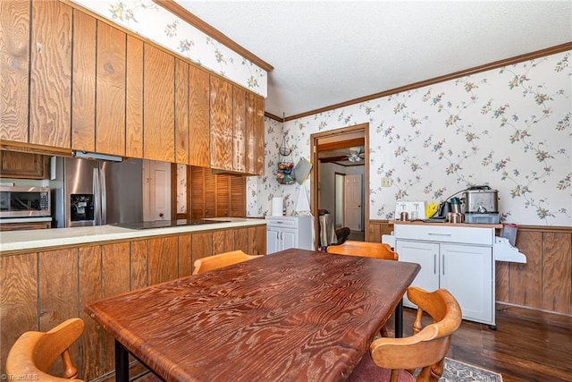 6215 Russwood Dr, Pleasant Garden, NC 27313 - kitchen featuring stainless steel appliances, wallpapered walls, crown molding, wainscoting, and dark wood-style floors