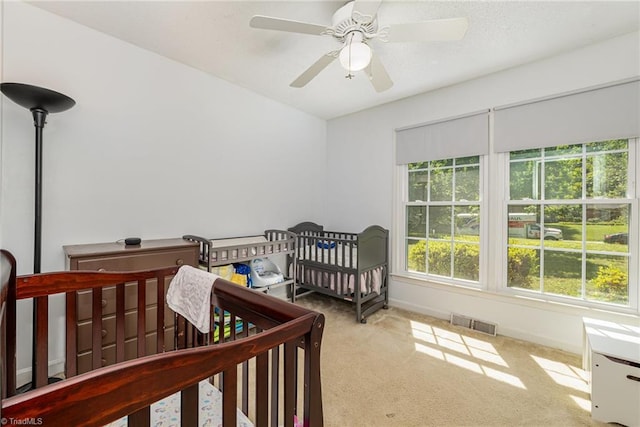6215 Russwood Dr, Pleasant Garden, NC 27313 - bedroom with carpet floors, baseboards, a crib, and ceiling fan