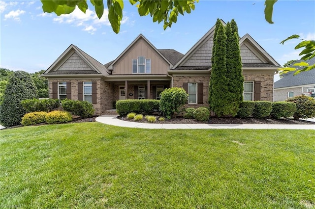 601 Rachel Smothers Dr, Greensboro, NC 27455 - craftsman-style house with brick siding, a front yard, and board and batten siding