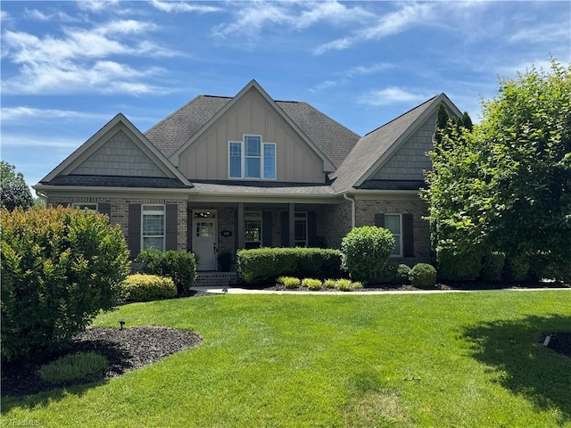 601 Rachel Smothers Dr, Greensboro, NC 27455 - craftsman inspired home with a front lawn, board and batten siding, a porch, and brick siding