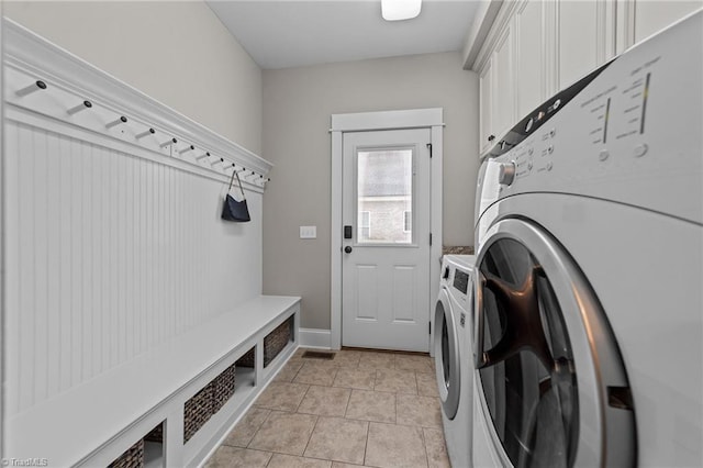 601 Rachel Smothers Dr, Greensboro, NC 27455 - laundry area with independent washer and dryer, cabinet space, and light tile patterned floors