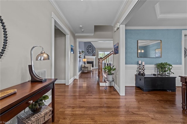 601 Rachel Smothers Dr, Greensboro, NC 27455 - foyer featuring wood finished floors, a fireplace, and crown molding