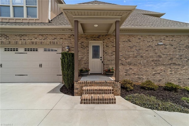 601 Rachel Smothers Dr, Greensboro, NC 27455 - property entrance featuring brick siding, roof with shingles, board and batten siding, concrete driveway, and a garage