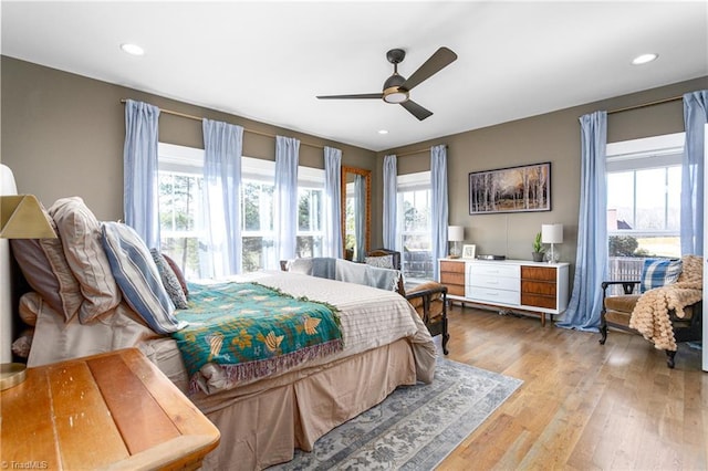 bedroom with light wood-style floors, multiple windows, a ceiling fan, and recessed lighting